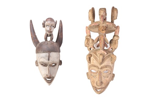 Lot 217 - Two Igbo carved wood masks, Nigeria, the...