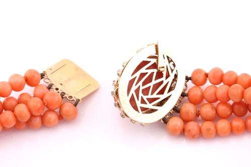 Lot 301 - A four row coral bead necklace, with four...