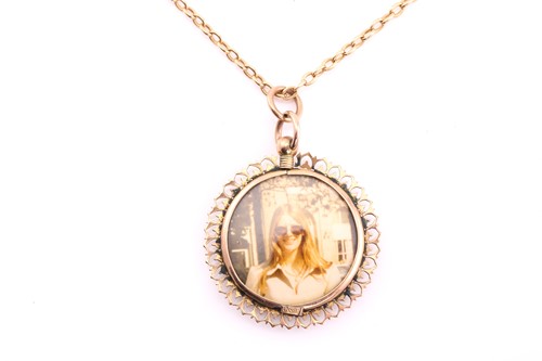 Lot 468 - A circular double sided locket pendant, with...