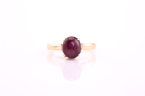 Lot 232 - A star ruby ring, the oval 7.7 by 6.5 by 5.3mm...