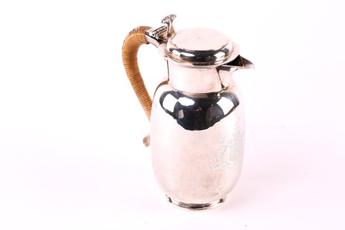 Lot 557 - A baluster shape silver hot water jug, rush...