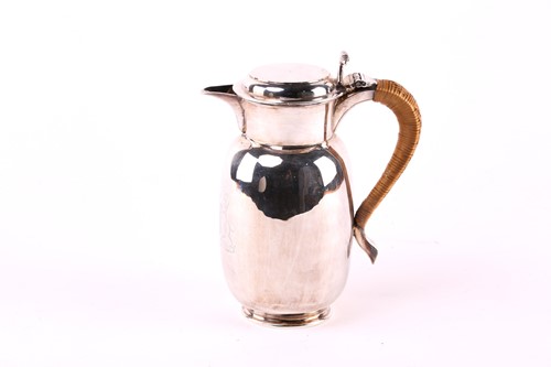 Lot 557 - A baluster shape silver hot water jug, rush...