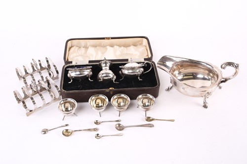 Lot 562 - A pair of 1930s silver four slice toast racks...