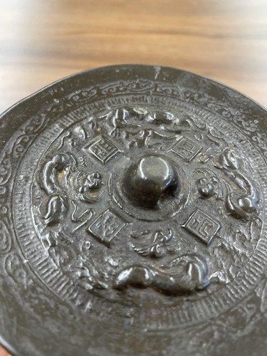 Lot 175 - A Chinese bronze mirror, possibly Han dynasty,...