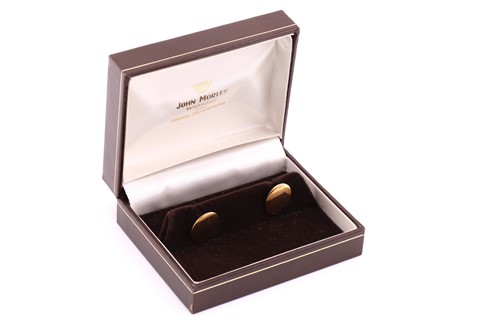 Lot 26 - A pair of 18ct gold cufflinks, of plain oval...