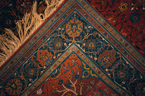 Lot 330 - An Eastern crimson ground silk on silk rug,...