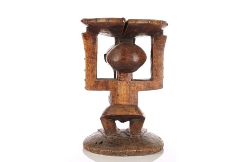 Lot 55 - Three Songye carved hardwood caryatid stools,...