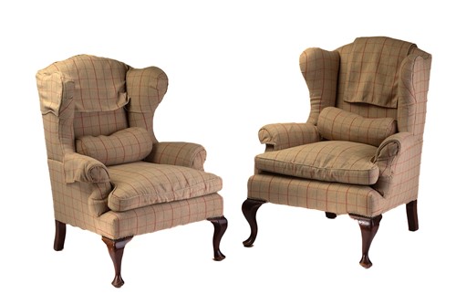 Lot 320 - A close pair of George III style wingback...