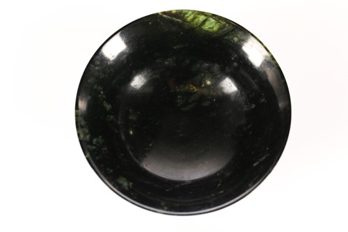 Lot 133 - An Eastern black/green circular Bowenite bowl...