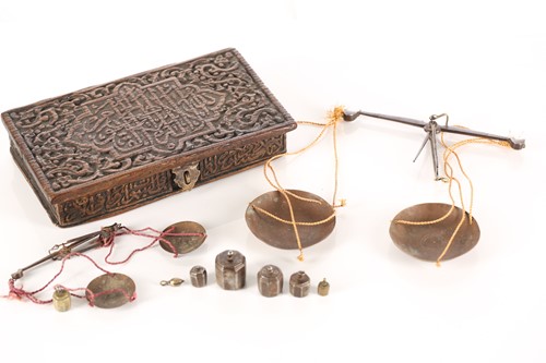 Lot 197 - An Eastern coin scale in a fitted teak case...
