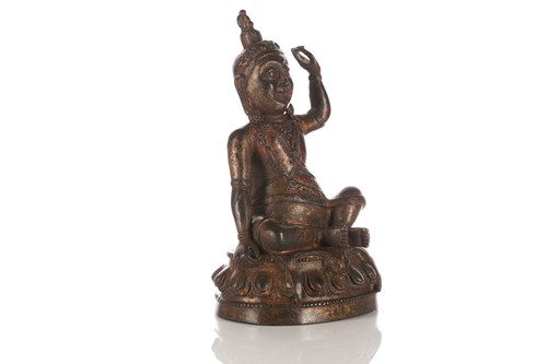 Lot 194 - A n Indian gilt-bronze figure of Milarepa (?)...