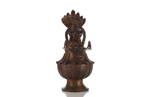 Lot 120 - A Nepalese gilt-bronze Sukunda (ritual oil...