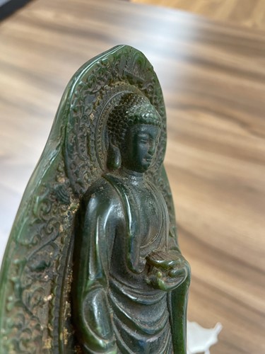 Lot 116 - A Chinese carved dark green jadeite figure of...