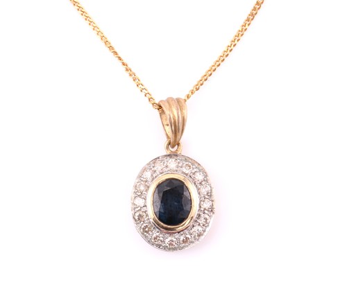 Lot 219 - A modern diamond and sapphire pendant,...