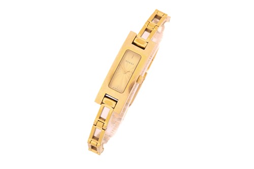 Lot 289 - A Gucci gilt metal watch, the rectangular...