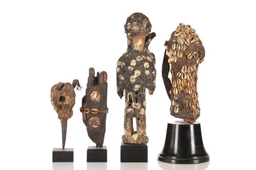 Lot 63 - A group of seven West African fetish figures,...