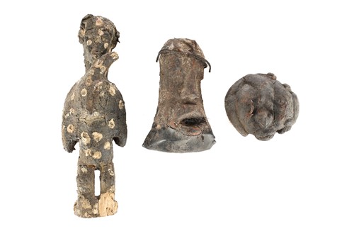 Lot 63 - A group of seven West African fetish figures,...