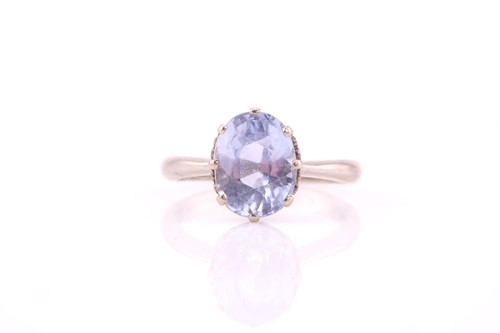 Lot 231 - A single stone pale sapphire ring; the oval...