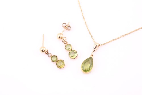 Lot 251 - A pear-cut peridot pendant, collet-set in...