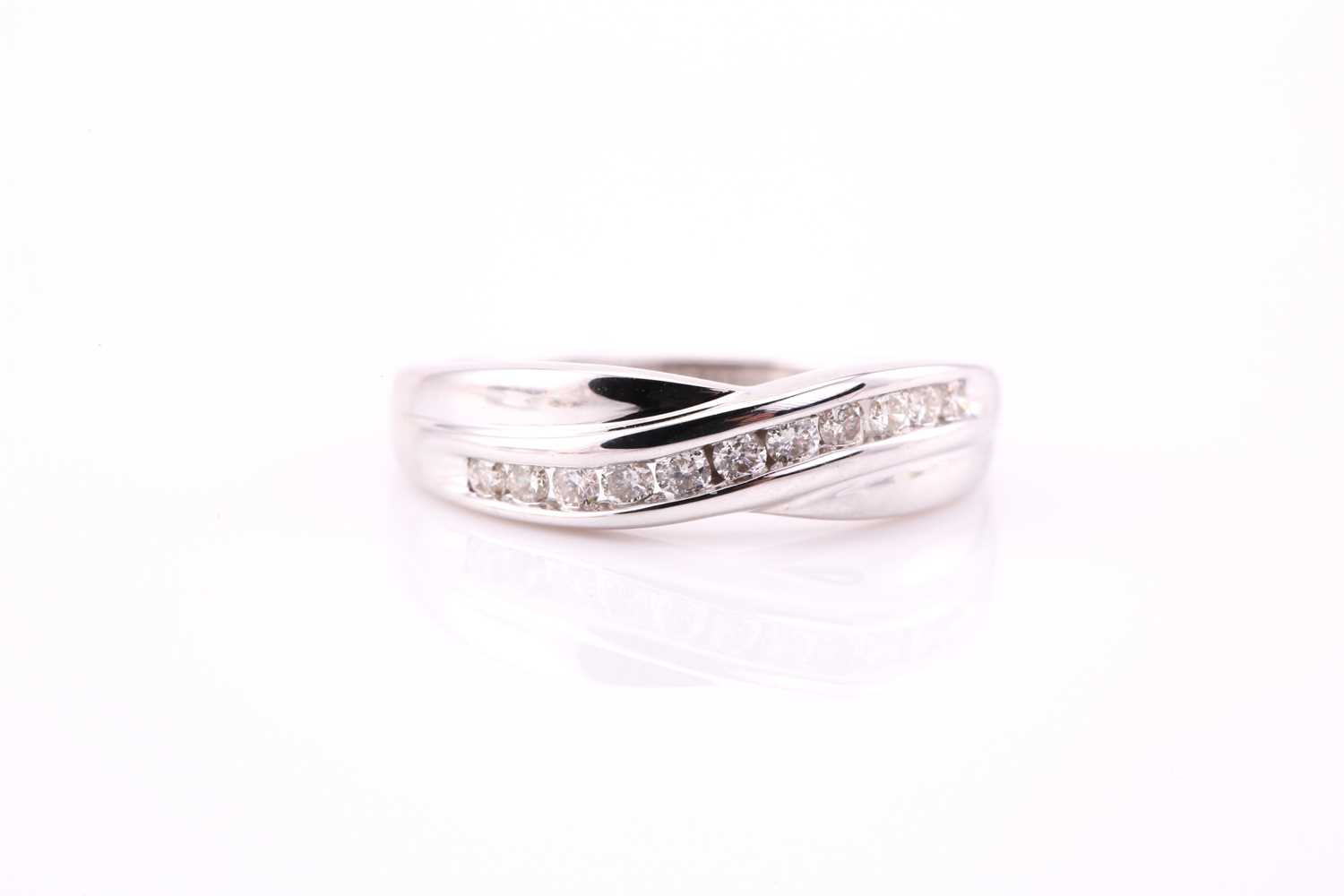 Lot 59 - A crossover half eternity ring, consisting of...