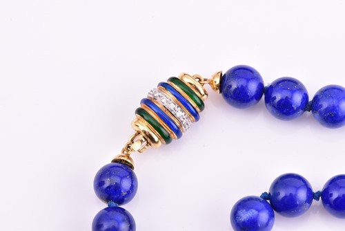 Lot 262 - A lapis lazuli bead necklace, with yellow...