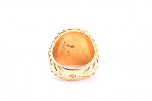 Lot 102 - A yellow metal and hematite intaglio ring,...