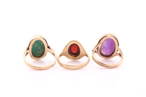 Lot 85 - Three cabochons set dress rings, the first...