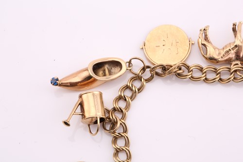 Lot 191 - A 9ct gold charm bracelet, consisting of a...