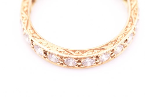 Lot 150 - An 18ct yellow gold and diamond eternity ring,...