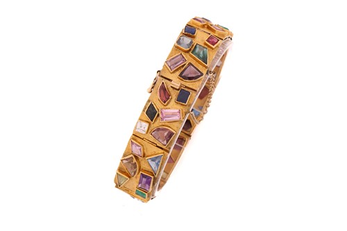Lot 141 - A Modernist coloured gem-set bracelet,...