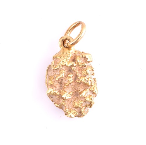 Lot 47 - A nugget pendant, a yellow metal charm and a...