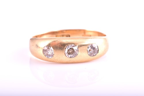 Lot 110 - A three-stone diamond ring; the slightly...