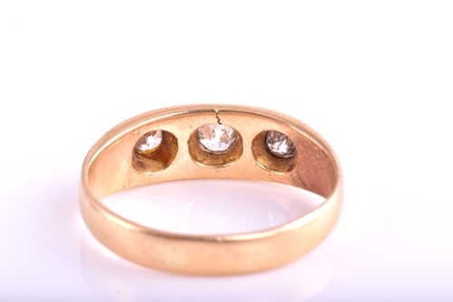 Lot 110 - A three-stone diamond ring; the slightly...