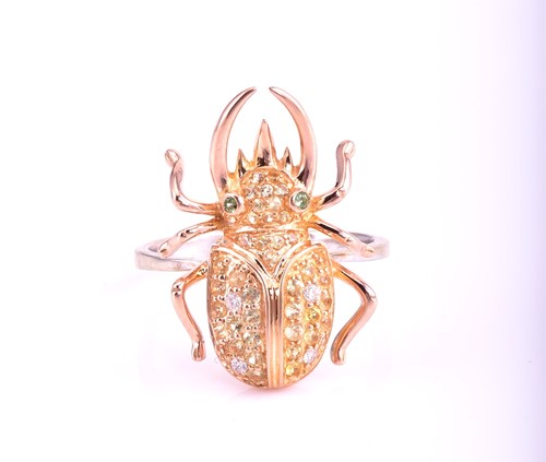 Lot 376 - A multi-gem set beetle ring; the 18 carat rose...