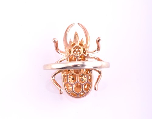 Lot 376 - A multi-gem set beetle ring; the 18 carat rose...