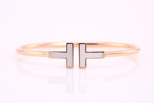 Lot 25 - Tiffany. A gold and mother of pearl T wire...