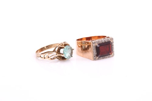 Lot 118 - A lot consists of a garnet halo ring and a...
