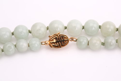 Lot 143 - A hand-knotted jade bead necklace, comprises a...