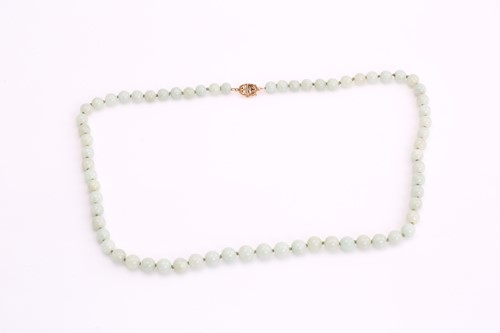 Lot 143 - A hand-knotted jade bead necklace, comprises a...