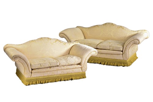 Lot 321 - A pair of Harrods camel back two-seat sofas...