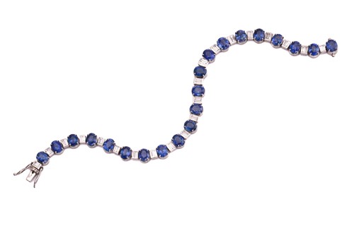 Lot 228 - A sapphire and diamond tennis bracelet,...