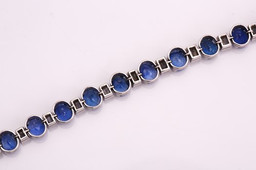 Lot 228 - A sapphire and diamond tennis bracelet,...