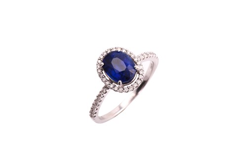 Lot 19 - A sapphire entourage ring, consisting of an...