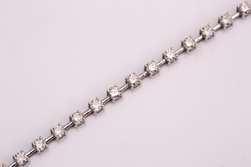 Lot 150 - A diamond tennis bracelet, consisting of 31...