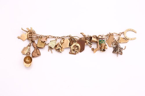 Lot 238 - A 9ct gold charm bracelet, consisting of a...