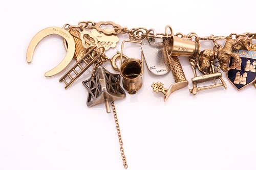 Lot 238 - A 9ct gold charm bracelet, consisting of a...