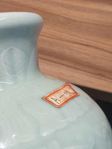 Lot 121 - A Chinese celadon glaze vase, the neck with...