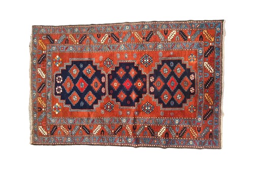 Lot 402 - A brick red ground Kazak rug, 20th century,...