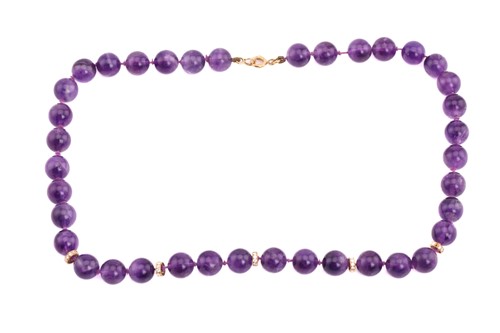 Lot 165 - An amethyst and diamond bead necklace; the...