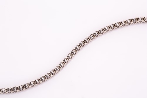 Lot 248 - A diamond line bracelet; the round brilliant...